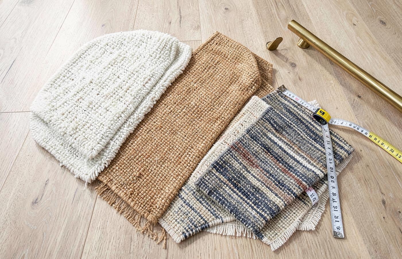 Wool, sisal and synthetic carpet samples laid out for comparison